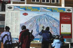 Skiers check out the trail map at Stratton.