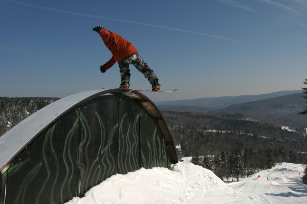 A snowboarder jibs in Snowshoe's  terrain park.