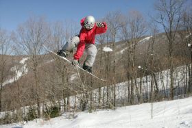 Snowboarder flying high at Jiminy Peak.