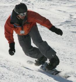 A rider out on the slopes with a Dual Edge snowboard by Deuce.