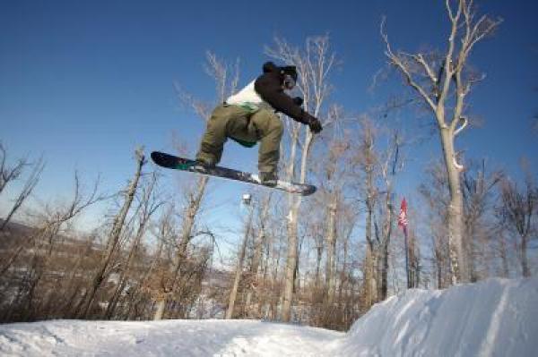 Snowboarder getting some air.