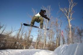 Snowboarder getting some air.