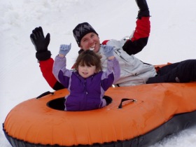 Kids of all ages love to slide down a hill in a tube.