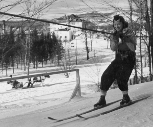 A skier rides a rope tow in the early days of skiing at Gray Rocks.