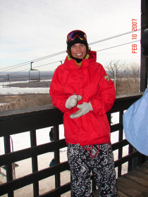 Mason Aguirre on the deck at Spirit Mountain's day lodge with Duluth harbor in the background.