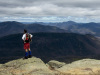 Hiker enjoys the view from Mt. Lafayette, above the Greenleaf Hut.  Photo by Mike Kautz. Courtesy of AMC.