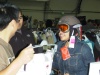 A visitor to Bay Area SkiDazzle checking out a helmet and goggles. Photo Credit/Copyright: Ski Dazzle LLC.