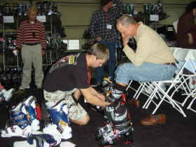A visitor getting fitted for new boots at the Colorado Ski & Snowboard Expo.