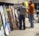 A couple examining snowboards at Seattle SkiFever.