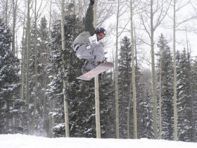 A snowboarder takes flgiht at Sunrise Park Resort.