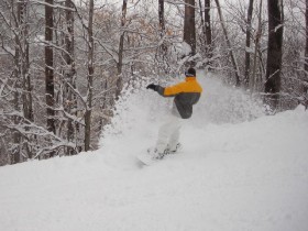 A snowboarder savors fresh snows at Cranmore.