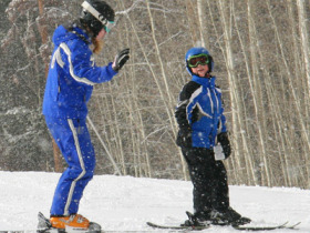 A boarder gets a lesson at Vail.