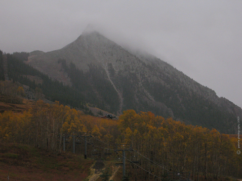 Rainy Wednesday in Crested Butte : : : : : : : : : : : :
Hi All—Wednesday’s shot is the ol’ standard of the peak from the base area. We have quite moist conditions this morning, with rain and low clouds covering the valley. While there is a forecasted high in the mid 50’s today, temps will drop overnight and should stay much cooler for Thursday. That’ll change our rain to snow, especially at higher elevations.
: : : : : : : : : : : :
Stay dry out there today and we’ll catch you tomorr