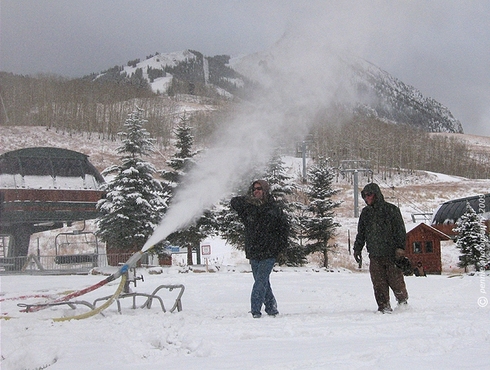 Training Up the Crew      : : : : : : : : : : : :   
Friday’s second shot is of snowmaker training in the base area.  The snowmaking team was practicing safely & efficiently setting up and taking down the pictured gun, as well as adjusting the air/water output to get the right snow consistency.  Chris is holding out his arm in the standard snowmaker pose, letting the snowflakes land there, so that he can examine them and decide if there should be more or less moisture content.  If you look carefully at the background, you can see a couple of other trainees working the hydrant, in front of the Silver Queen lift shack.  
      : : : : : : : : : : : :   One more shot . . .
