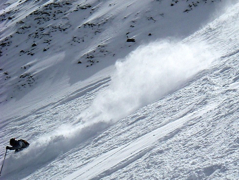 This skier dove into the deep powder off the Headwaters Ridge for some exciting turns that left clouds of cold smoke to reflect the sunshine. Photo by Benjamin Daniel, Mountain Reporter 