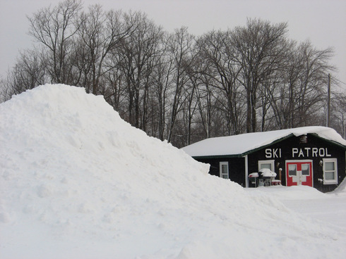 Snowpile dwarfs Ski Patrol Headquarters at Indianhead
